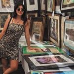 Yound woman in leopard dress at art booth